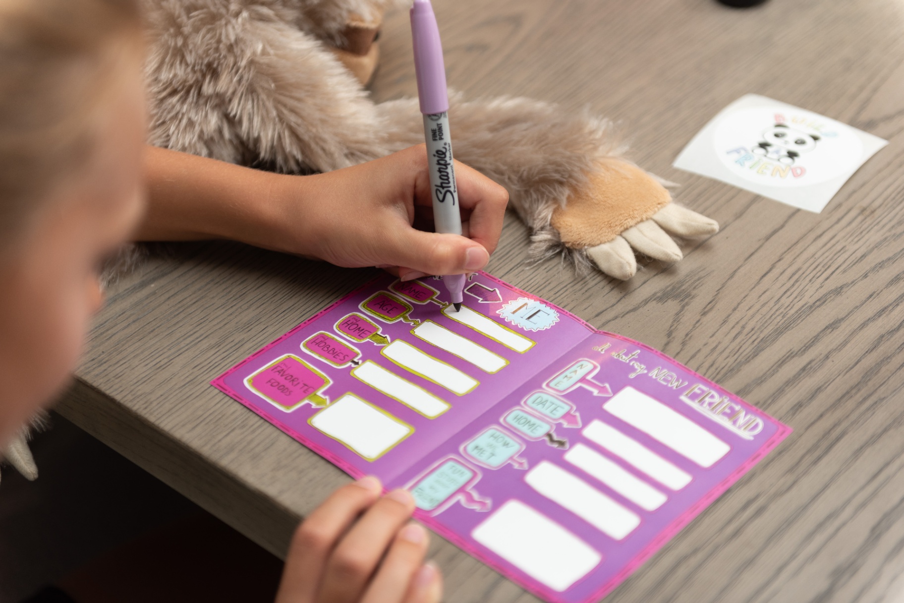 Child filling out adoption certificate