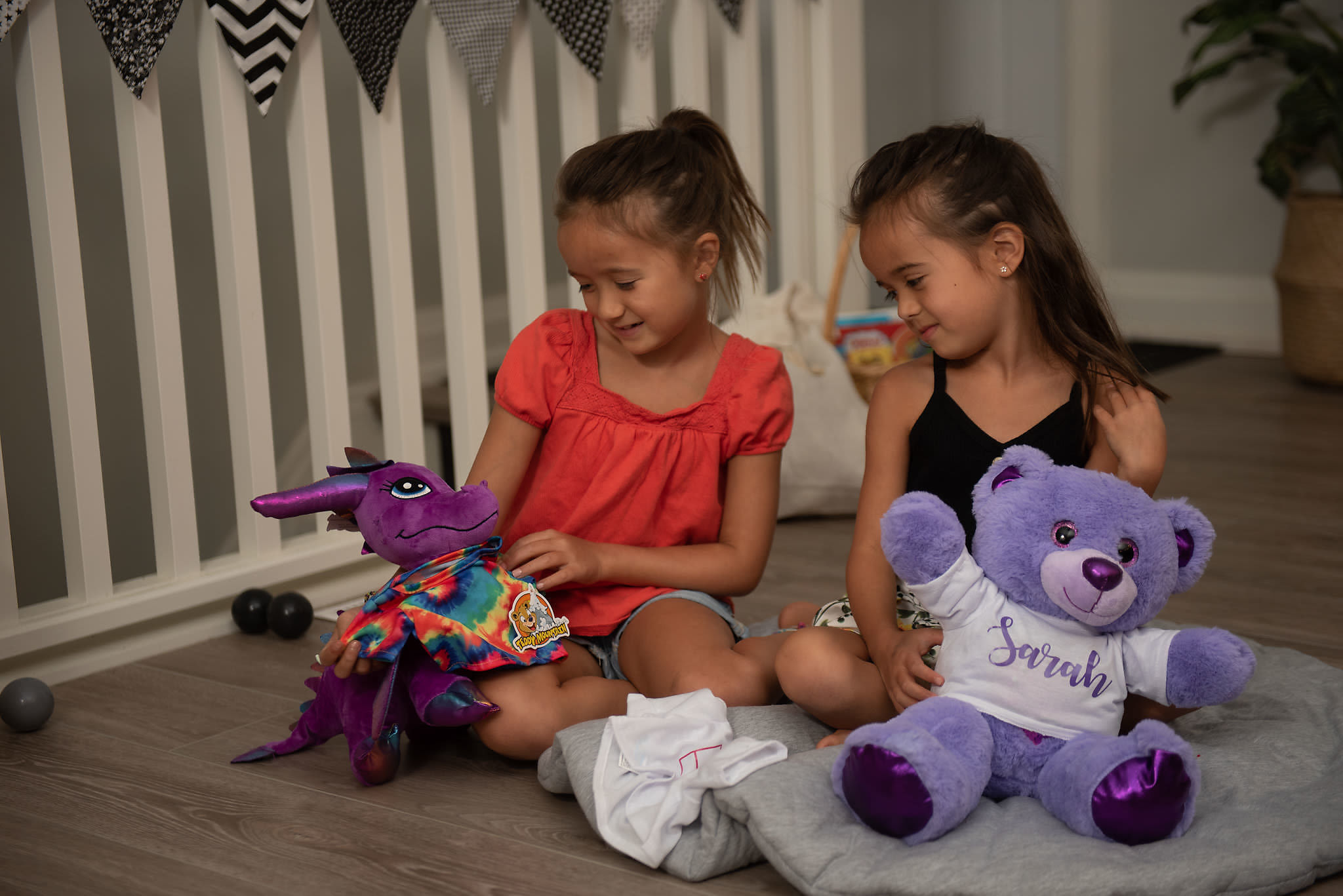 Kids playing with finished Build A Friend stuffed animals