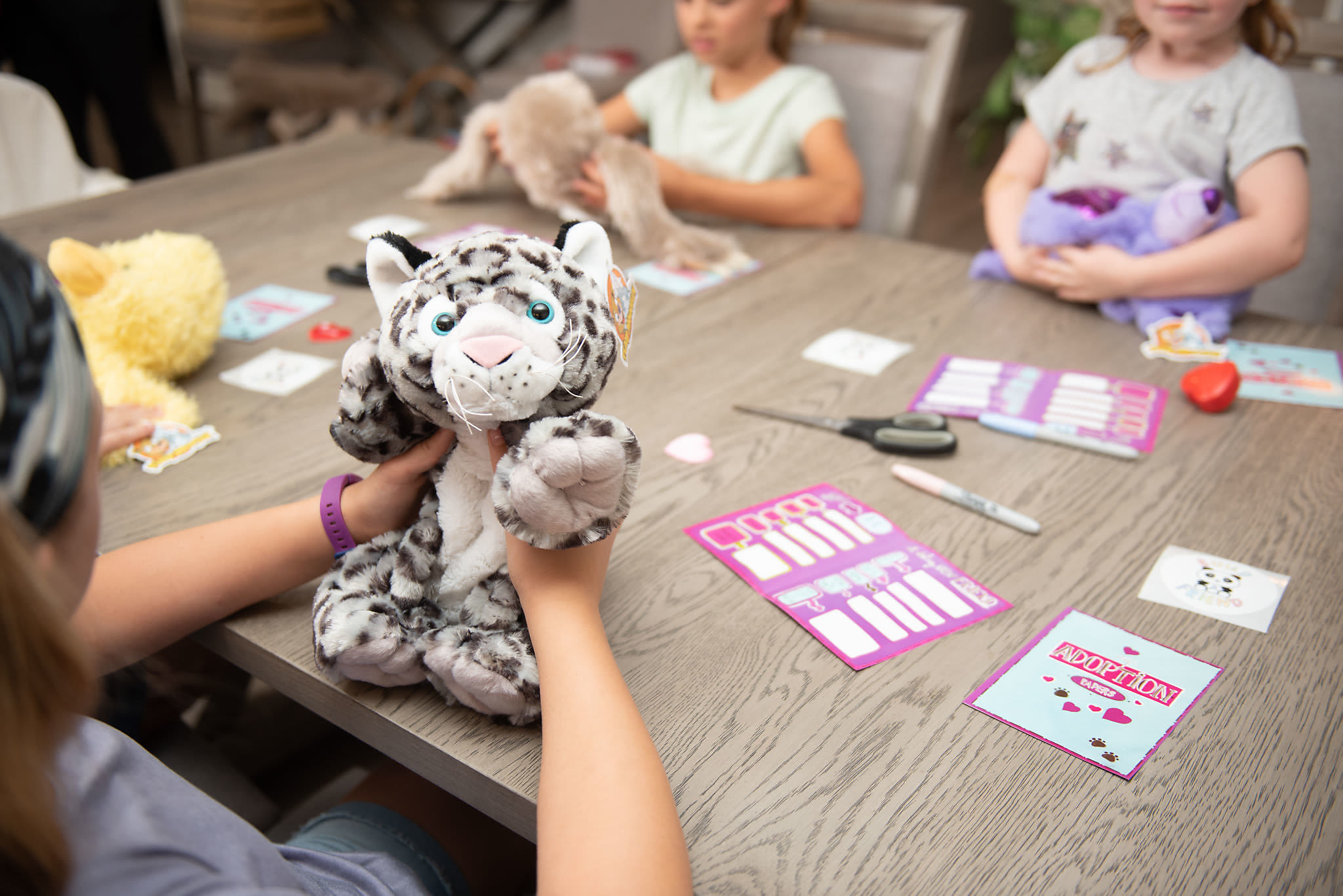 Kids celebrating a Build A Friend birthday party with their stuffed animals
